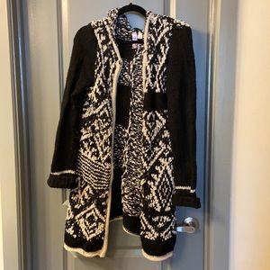 Long, woven Anthropologie sweater.